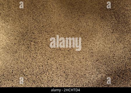 black spray paint on gold colored paper Stock Photo