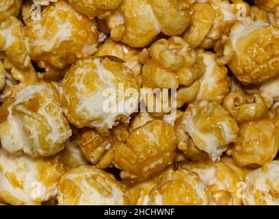 Caramel popcorn kernels up close with details and textures from directly above, selective focus. Stock Photo