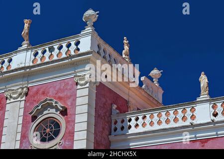 NeoRococo palace-pink façade facing the gardens-porthole window-white balustrade-rooftop statues. Estoi-Algarve-Portugal-017 Stock Photo