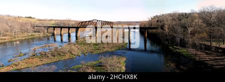 Historic iron swing bridge over the White River, near Cotter Arkansas. Old steel truss railroad bridge built in 1905, stretches 285 feet long. Stock Photo