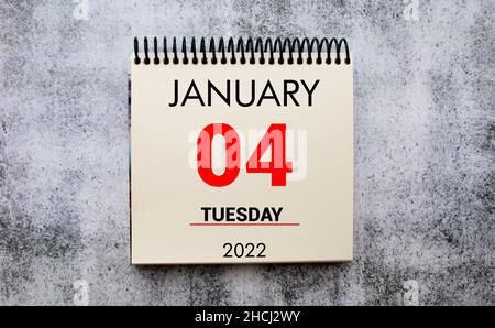 January 4 on a white Notepad .Next to it is a blue clock on a red background.Calendar for January Stock Photo