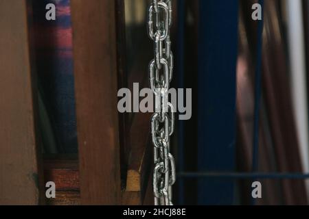 Closeup shot of a silver chain on blurred background Stock Photo