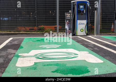 EV logo painted on the parking bay for EV Charging point supplied by BP Pulse London England UK Stock Photo