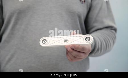 Man collects furniture in a workshop. Stock. Bonding and assembly of furniture on the wooden pins Stock Photo