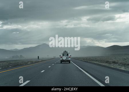 White van with Alaska state license plates driving on EB I-80 near Lovelock, Nevada, USA Stock Photo