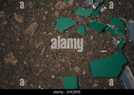 Close-up shot of broken glass on the ground Stock Photo