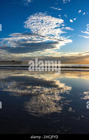 Vertical shot of the sky clouds reflecting on the sea surface Stock Photo