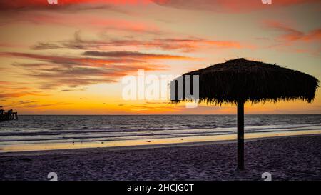 Silhouette shot of a tiki hut umbrella at the San Clemente seashore Stock Photo