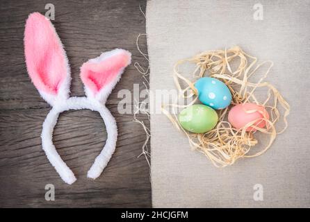 Bunny ears and Easter eggs on wooden background Stock Photo