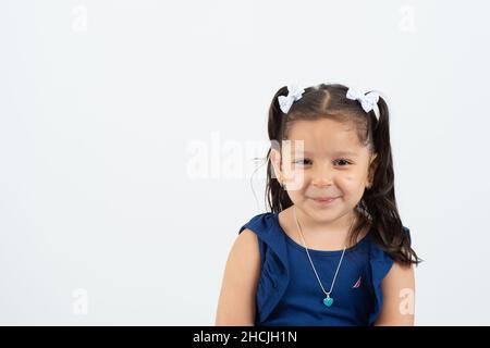Closeup portrait of 4 or 5 year old girl, smiling, white background Stock Photo