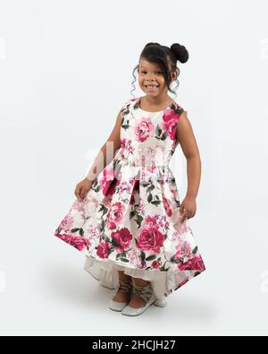 full length portrait of 4 or 5 year old girl, smiling, white background, in dress up dress Stock Photo