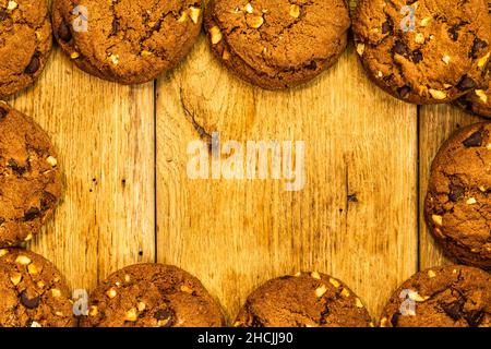 Frame made of chocolate chip cookies, biscuits, top view with copy space. Stock Photo