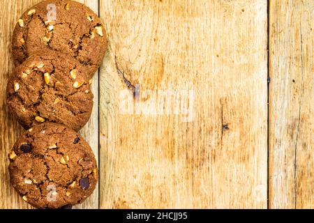 Biscuits on wooden table. Chocolate cookies on the table, breakfast concept. Top view with copy space Stock Photo