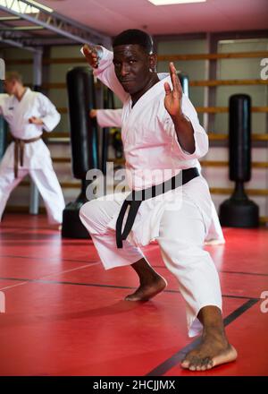 African american man in kimono fighting stance at karate training closeup Stock Photo