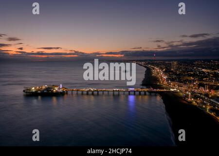 The Seafront Palace Pier in Brighton Illuminated at Night Aerial View Stock Photo