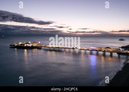 The Seafront Palace Pier in Brighton Illuminated at Night Aerial View Stock Photo