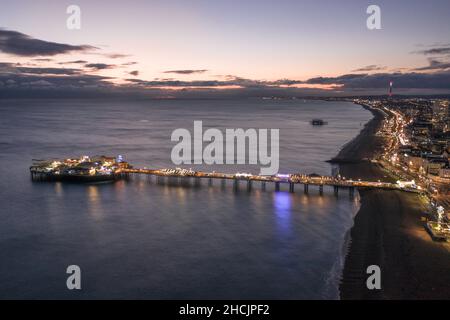 The Seafront Palace Pier in Brighton Illuminated at Night Aerial View Stock Photo