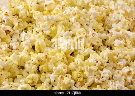 Heap of fresh hot buttered microwaved popcorn food closeup background Stock Photo