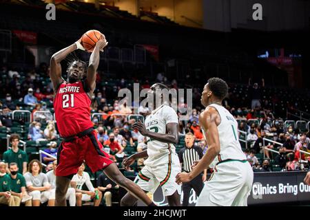 Coral Gables, Florida, USA. 29th Dec. 2021. 21 Ebenezer Dowuona  during the Men’s Basketball between Miami Hurricanes vs NC State in Watsco Center. Credit: Yaroslav Sabitov/YES Market Media/Alamy Live News Stock Photo