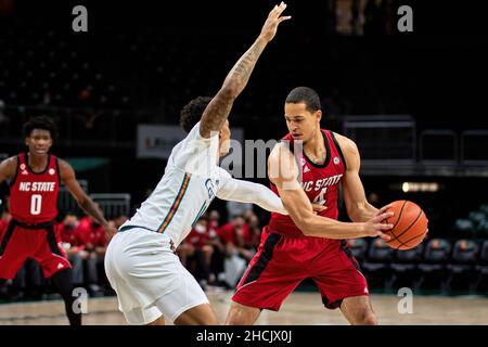 Coral Gables, Florida, USA. 29th Dec. 2021. 4 Jericole Hellems during the Men’s Basketball between Miami Hurricanes vs NC State in Watsco Center. Credit: Yaroslav Sabitov/YES Market Media/Alamy Live News Stock Photo