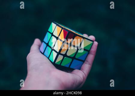 KORONADAL, PH – DEC 13, 2021: Rubik's Cube was invented in 1974 by Hungarian sculptor and professor of architecture Erno Rubik. Hand holding completed Stock Photo