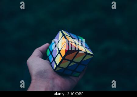 KORONADAL, PH – DEC 13, 2021: Rubik's Cube was invented in 1974 by Hungarian sculptor and professor of architecture Erno Rubik. Hand holding completed Stock Photo