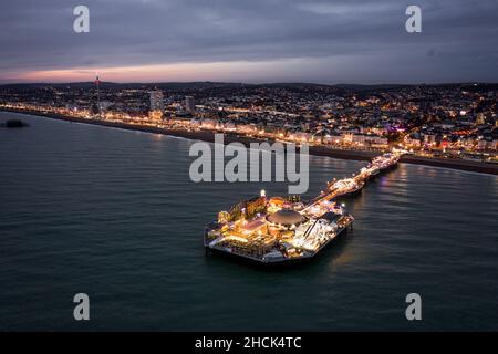 The Seafront Palace Pier in Brighton Illuminated at Night Aerial View Stock Photo