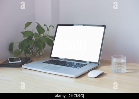 workplace in the corner, computer, mouse, water on the table Stock Photo