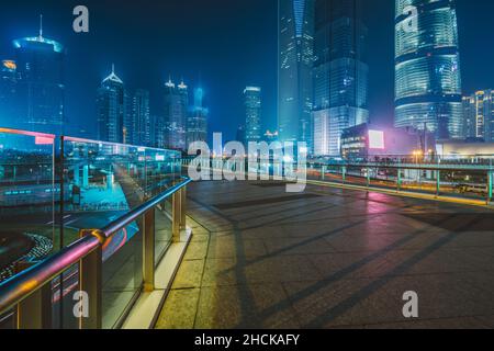 cityscape and skyline of shanghai from empty brick floor at night Stock Photo