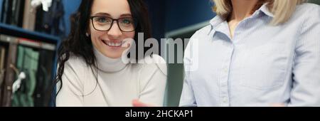 Woman designer showing project on digital tablet in curtain salon Stock Photo