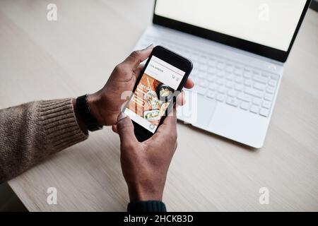 Close up of unrecognizable person using smartphone with food delivery app, copy space Stock Photo