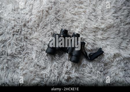 Black binoculars for opera, concert and bird watching on gray background Stock Photo