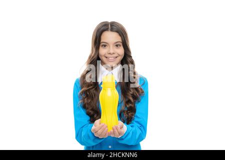 Enjoy yogurt for breakfast. Happy child hold yellow bottle isolated on white. Enjoy every sip Stock Photo