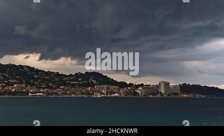 Beautiful view of town Sainte-Maxime, a popular holiday destination at the French Riviera, on stormy day in autumn season with thuderstorm clouds. Stock Photo