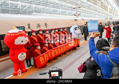 (211230) -- BEIJING, Dec. 30, 2021 (Xinhua) -- Reporters take photos during an event marking the two-year anniversary of the opening of the Beijing-Zhangjiakou high-speed railway at the Beijing North Railway Station in Beijing, capital of China, Dec. 30, 2021. The high-speed railway connecting Beijing and Zhangjiakou in north China's Hebei Province went into service on Dec. 30, 2019. (Photo by Fang Xin/Xinhua) Stock Photo