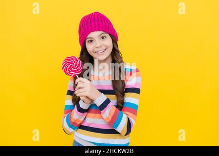 lollipop lady. hipster kid with colorful lollypop sugar candy on stick. caramel candy shop. Stock Photo