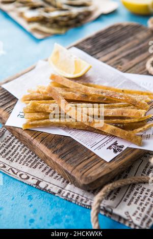 Dried and salted tuna in a wooden board  Beer snack Stock Photo