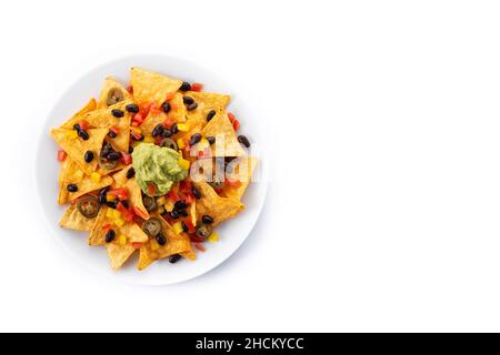 Mexican nachos tortilla chips with black beans, guacamole, tomato and jalapeno isolated on white background Stock Photo