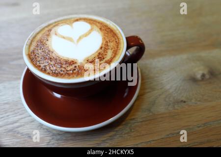 A cappuccino coffee with decorated heart design coffee art Stock Photo