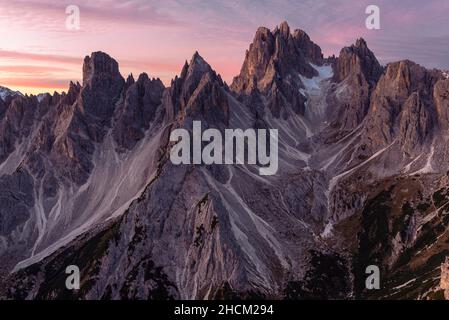 View from Monte Campedelle of the Cadini mountain group at dawn, Sexten Dolomites, Belluno, Italy Stock Photo