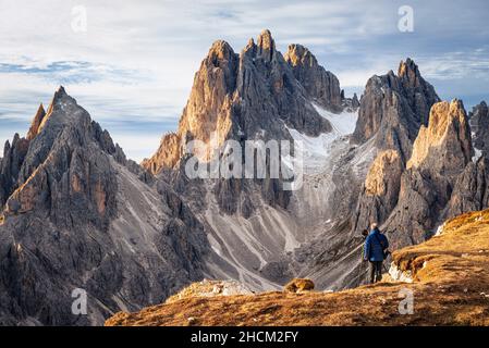 Photographer in front of the Cadini di Misurina mountain massif in the Sexten Dolomites at sunrise, South Tyrol, Italy Stock Photo