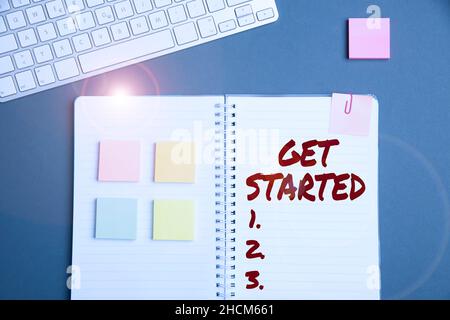 Handwriting text Get Started. Business overview to begin accomplishing or working on the tasks to finish it Keyboard Over A Table Beside A Notebook Stock Photo