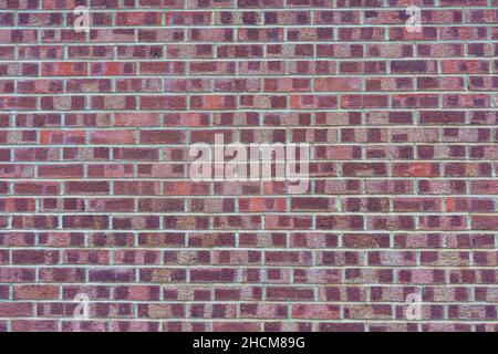 Large section of brick wall with differing red colors throughout Stock Photo
