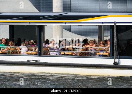 Close up view of crowd of people on city sightseeing tour cruise boat on Spree River on sunny summer in Berlin. Stock Photo