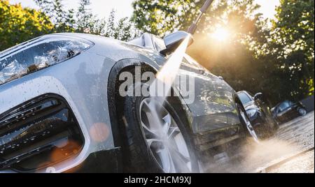 Car washing. Cleaning Car Using High Pressure Water. Stock Photo