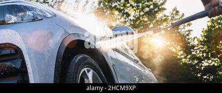 Car washing. Cleaning Car Using High Pressure Water. Stock Photo