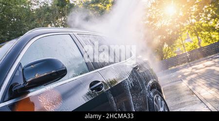 Car washing. Cleaning Car Using High Pressure Water. Stock Photo