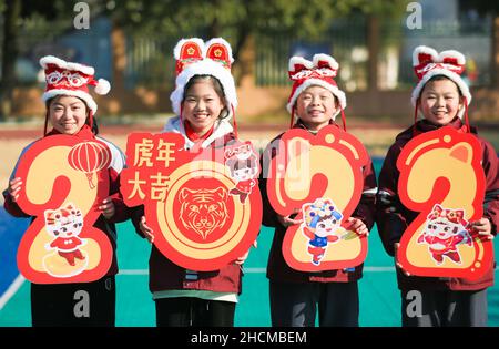 Huzhou, China's Zhejiang Province. 30th Dec, 2021. Pupils celebrate the upcoming New Year in Huzhou, east China's Zhejiang Province, Dec. 30, 2021. Schools and kindergartens across China organize various kinds of activities as the New Year approaches. Credit: Wang Zheng/Xinhua/Alamy Live News Stock Photo