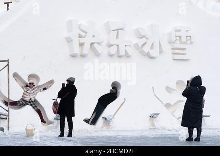 Harbin, China's Heilongjiang Province. 30th Dec, 2021. Tourists have fun at an ice-snow theme park in Harbin, northeast China's Heilongjiang Province, Dec. 30, 2021. Credit: Xie Jianfei/Xinhua/Alamy Live News Stock Photo