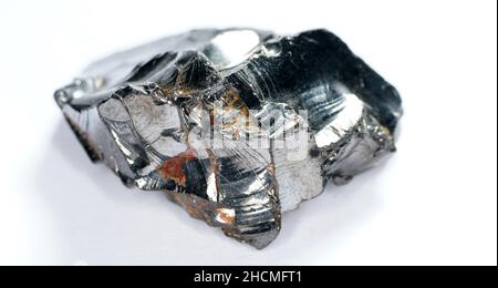 Shungit is a black rock that consists mainly of carbon and was photographed in top quality and studio quality. Stock Photo